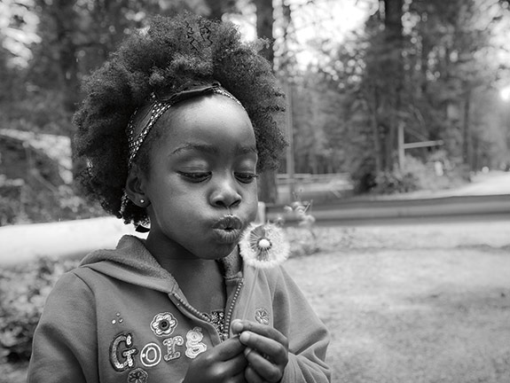 Child with dandelion