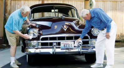 Two men polishing a classic car