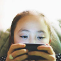 kid using smartphone for mobile gaming