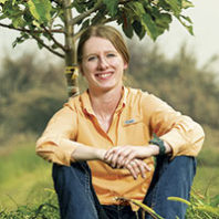 WSU horticulture doctoral student Sarah Kostick next to a tree