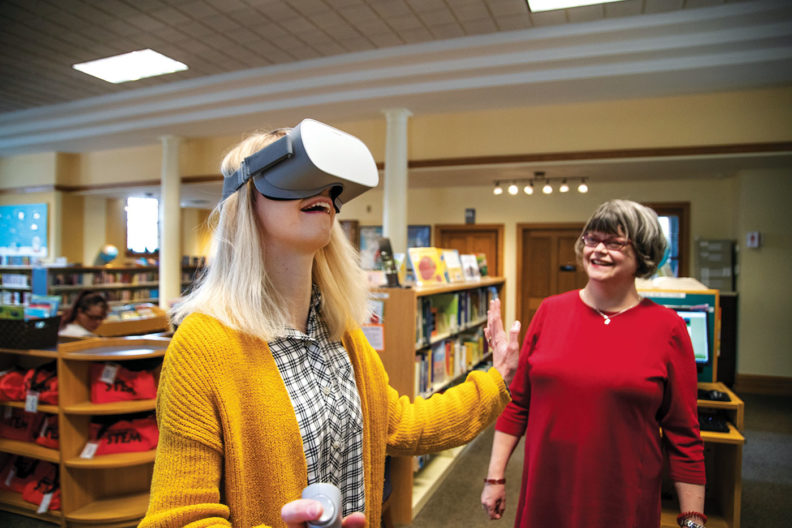 Sarah English introduces a patron to virtual reality at Colville Public Library