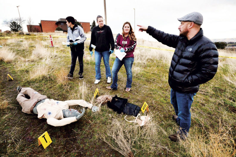 Matt DeGarmo critiquing forensic science students on their crime scene investigation in a field lab at Blue Mountain Community College in Pendleton, Oregon.