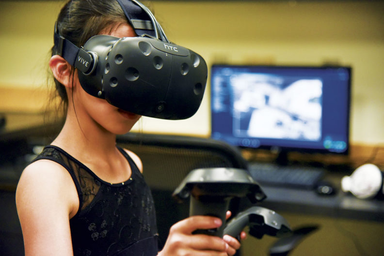 A girl tries out VR at WSU Tri-Cities