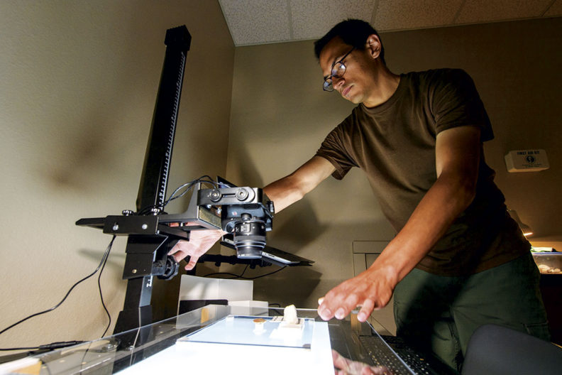 WSU student and veteran Trent Raymer takes photos of artifacts
