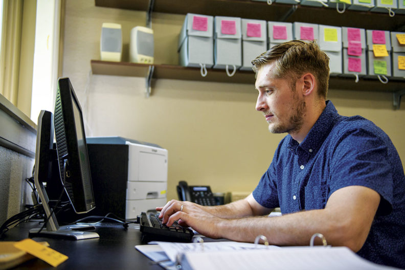 WSU student and veteran Stephen Bergquist works on a computer cataloging ancient artifacts