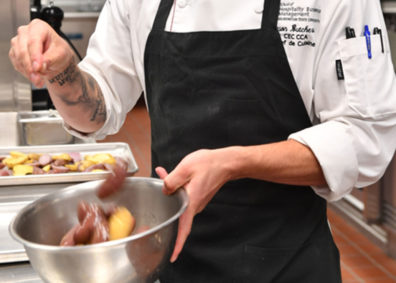 Sprinkling pepper on potatoes. Photo Shelly Hanks