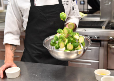 Tossing brussels sprouts with lemon juice. Photo Shelly Hanks