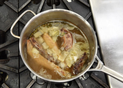 Simmering roast neck and wingtips with stock. Photo Shelly Hanks