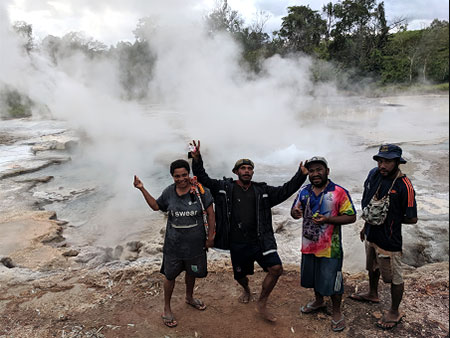 Four men in Papua New Guinea have a good time by rushing water