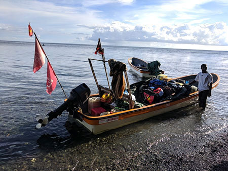 Loaded boat by shore in Papua New Guinea
