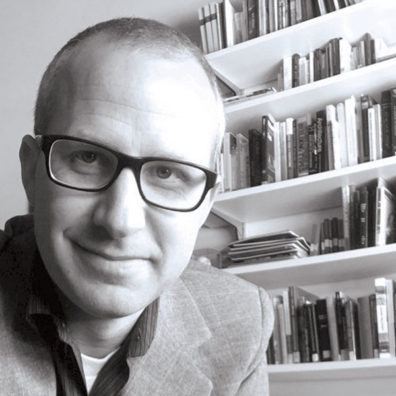 Ryan Smith with bookshelf behind him