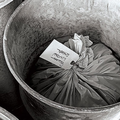 Plastic bag of ash from Mount St. Helens in a barrel stored near Pullman