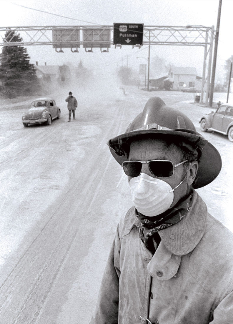 Colfax, Washington, firefighter wearing facemask next to US Highway 195