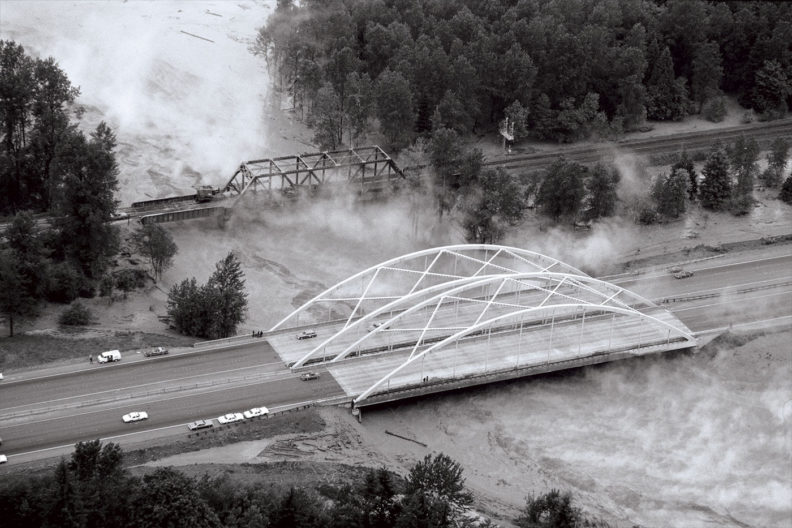 Steaming water flows under the I-5 Toutle River bridge in 1980
