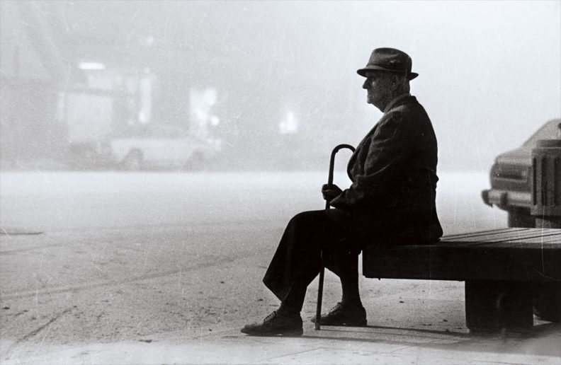 Man waits for a Spokane bus in blowing volcanic ash