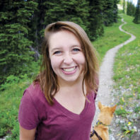 Jaime Chambers with her dog on a wooded path