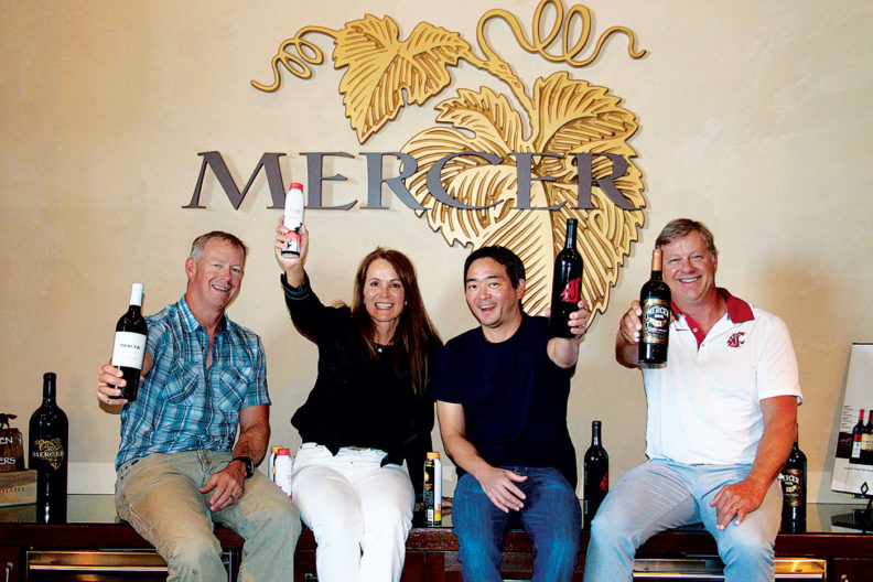 Mercer Estates staff raising bottles of their wine