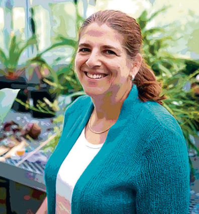 Cheryl Schultz in a greenhouse