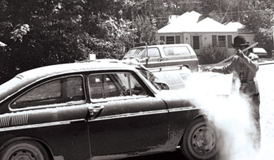 Danielle Dorrian (nee McGlone) in 1980 sweeps ash from Mount St. Helens off of her car.