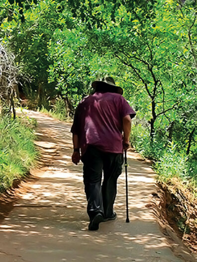 John Streamas walking along a path