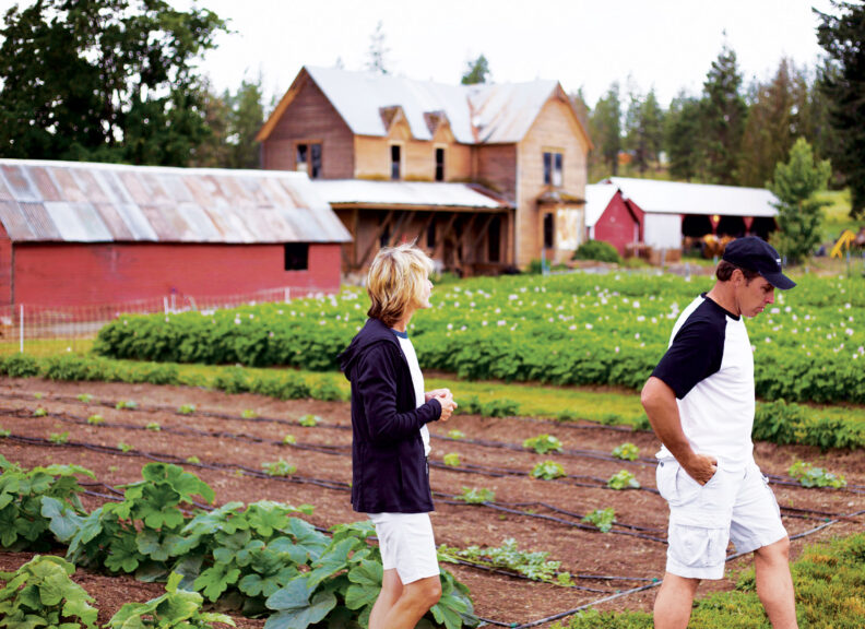 Jim and Connie Long walk in a field at Fresh Cut Farms