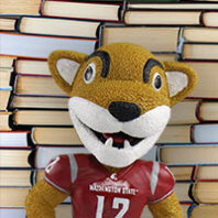 Butch Cougar in front of a pile of books