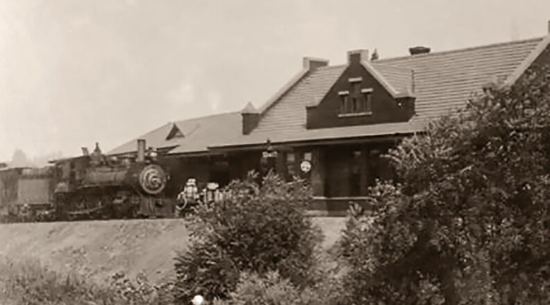 Train stopped in front of Pullman depot around 1920
