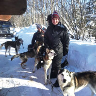 Laura White with sled dogs at the 2020 Iditarod Race