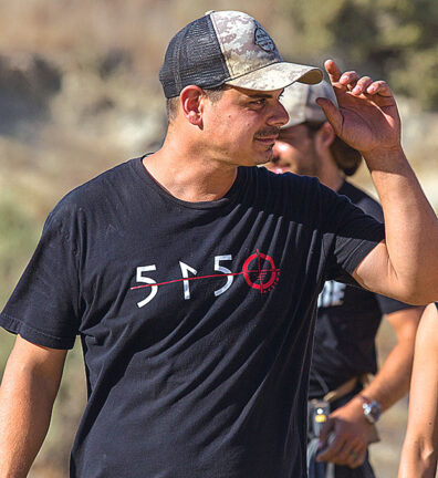 Andrew DeCesare in a baseball cap with a 5150 shirt directing Rogue Warfare