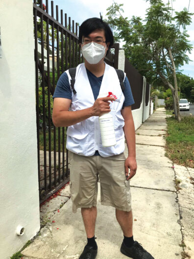 Wayne Chang in a mask on a sidewalk in Puerto Rico with Doctors Without Border