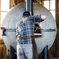 Removing bread from buoy oven at WSU Bread Lab