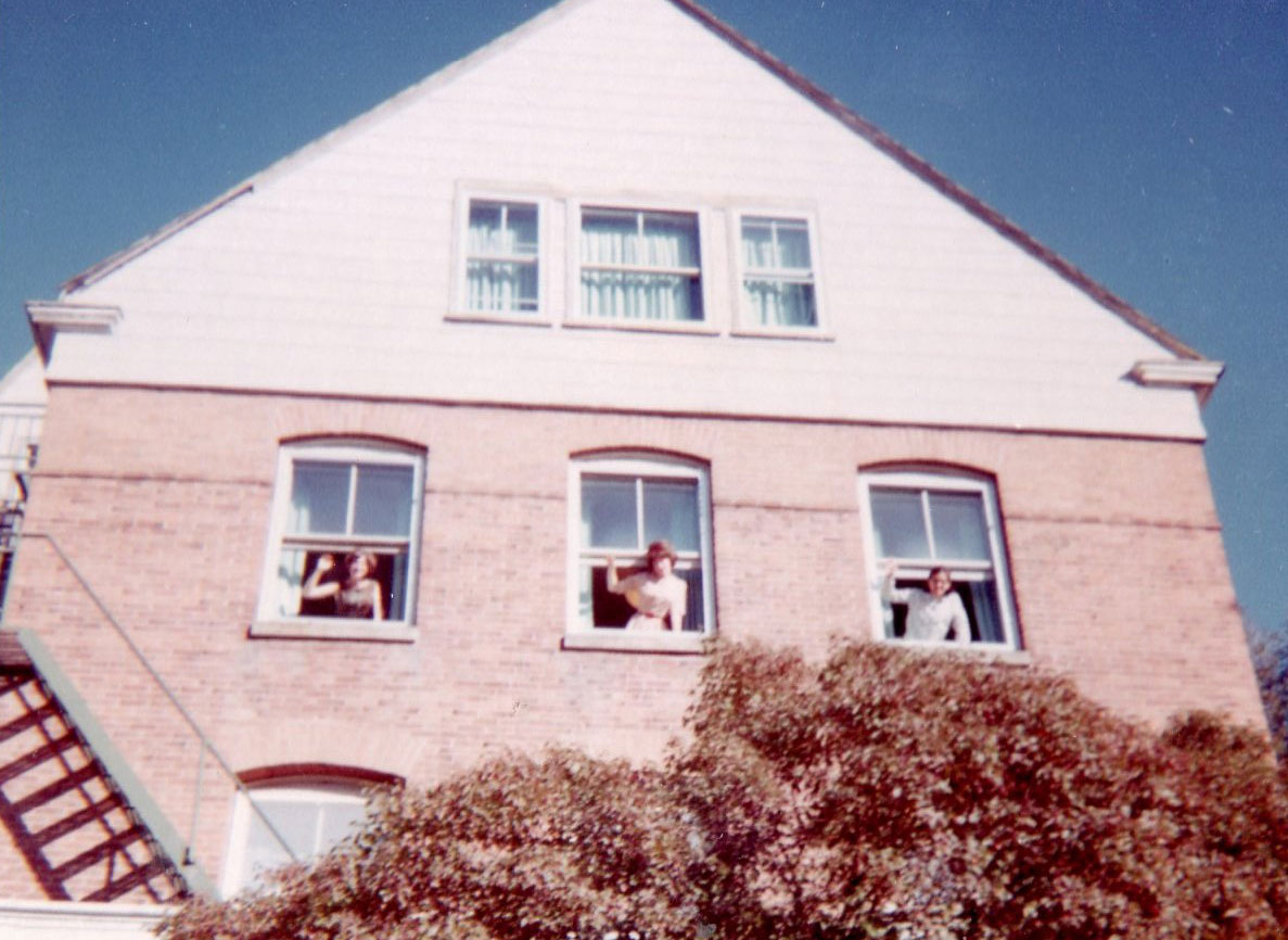 Stevens Hall 1964 with three women waving from windows