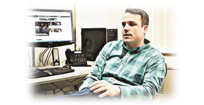 Ben Cowan seated in front of his computer