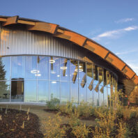 Windows reflecting light on the outside of Elson S. Floyd Cultural Center, with the meditation chamber on the left