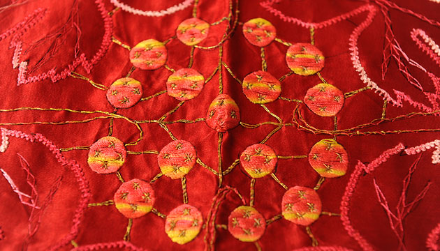 Appliqué and embroidery on red silk, early 20th century