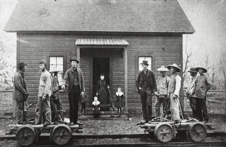 Chinese workers in front of a small building with the Oregon Railroad and Navigation Company