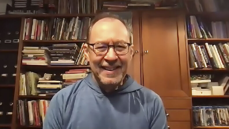 Rory Ong in front of bookshelves