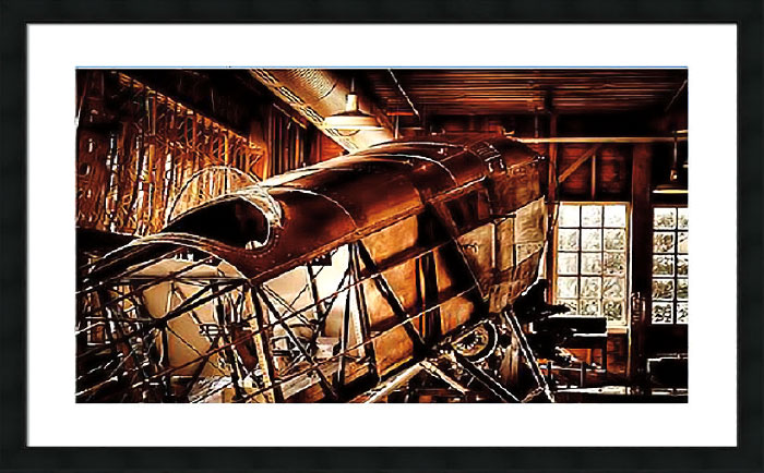 Photograph of old plane cockpit in a barn