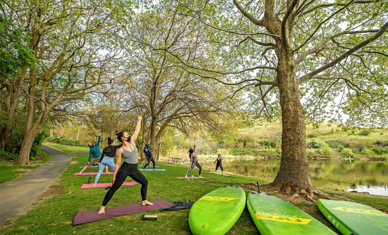 Young people in masks doing yoga outside near the Snake River in Washington