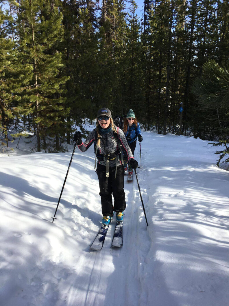 Two young women crosscountry skiing in a forest at Moscow Mountain in Idaho