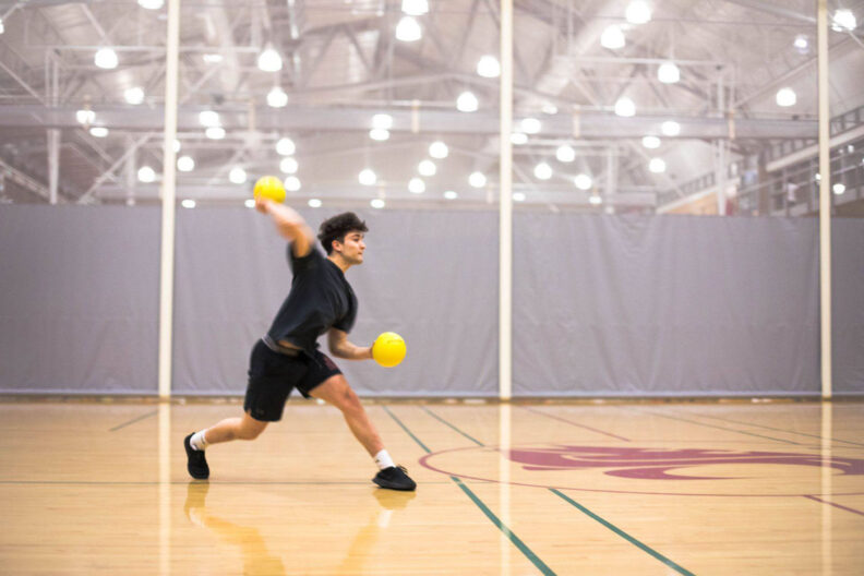 Young man plays dodgeball at WSU Student Recreation Center