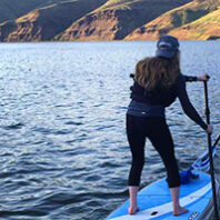 Woman on a paddleboard riding the Snake River