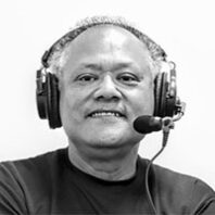 Enrique Cerna with headphones and microphone