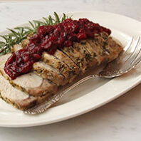 Pork with cranberry sauce on a plate