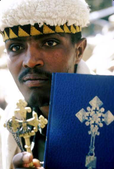 priest holds Ethiopian Orthodox bible