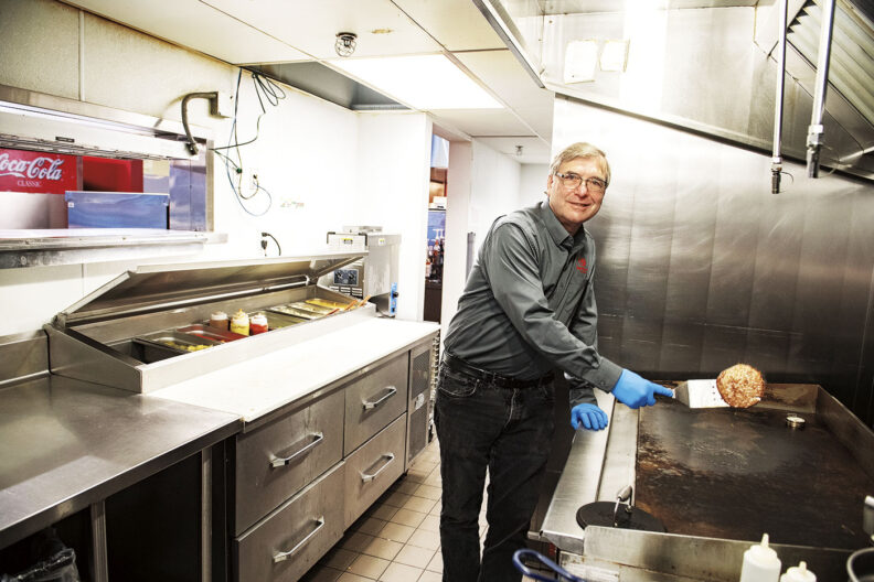 Michael Wagoner flips a burger at Cougar Country Underground at WSU student union building