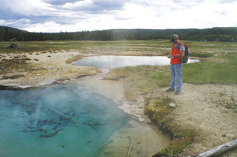 Washington State University student gathers geological data at a Yellowstone hot spring