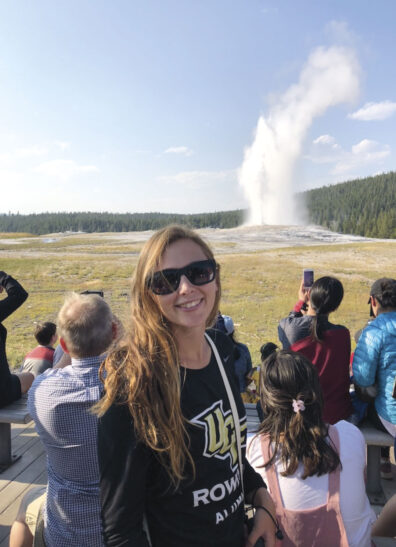 Olivia Hecimovich stands sin front a Yellowstone geyser