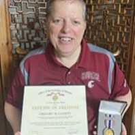 Deke Gassett holds his Secretary of Defense Medal for the Defense of Freedom