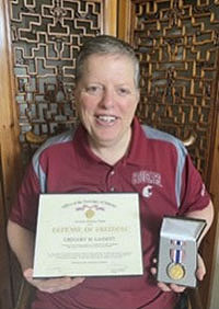 Deke Gassett holds his Secretary of Defense Medal for the Defense of Freedom